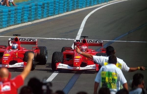 Formula One World Championship: Race winner and four-time World Champion Michael Schumacher Ferrari F1 2001 enters Parc Ferme with his team mate