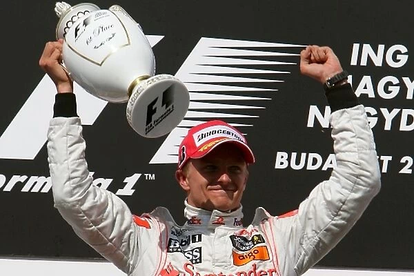 Formula One World Championship: Race winner Heikki Kovalainen McLaren on the podium