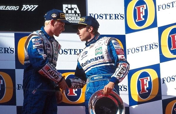 Formula One World Championship: Race winner Jacques Villeneuve shakes hands with his Williams team mate Heinz-Harald Frentzen who finished third
