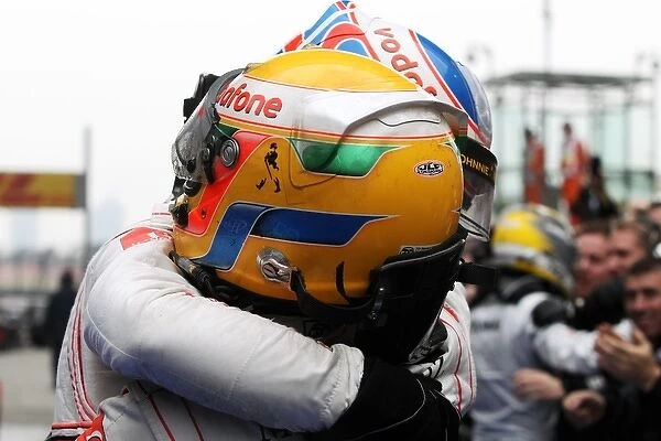 Formula One World Championship: Race winner Jenson Button McLaren celebrates with team mate Lewis Hamilton McLaren in parc ferme