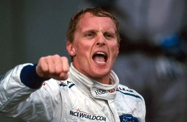 Formula One World Championship: Race winner Johnny Herbert, Stewart Grand Prix, celebrates on the podium