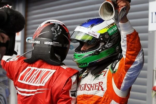 Formula One World Championship: Race winner Kimi Raikkonen Ferrari celebrates with second placed Giancarlo Fisichella Force India F1 in parc ferme