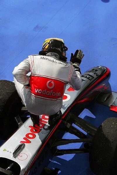 Formula One World Championship: Race winner Lewis Hamilton McLaren MP4  /  24 celebrates in parc ferme