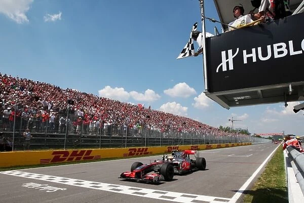 Formula One World Championship: Race winner Lewis Hamilton McLaren MP4  /  25 takes the chequered flag at the end of the race