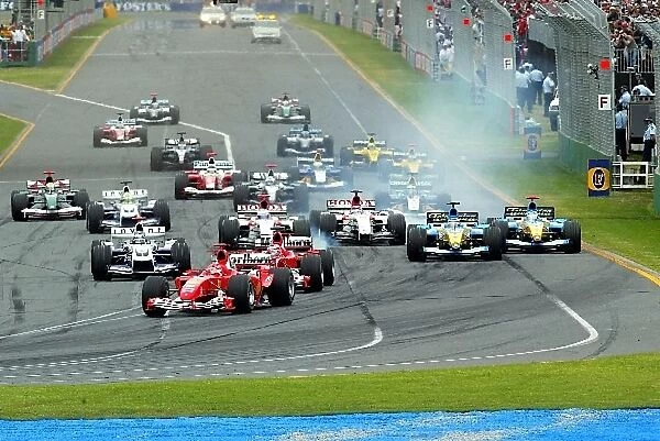 Formula One World Championship: Race winner Michael Schumacher Ferrari F2004 leads at the start of the race