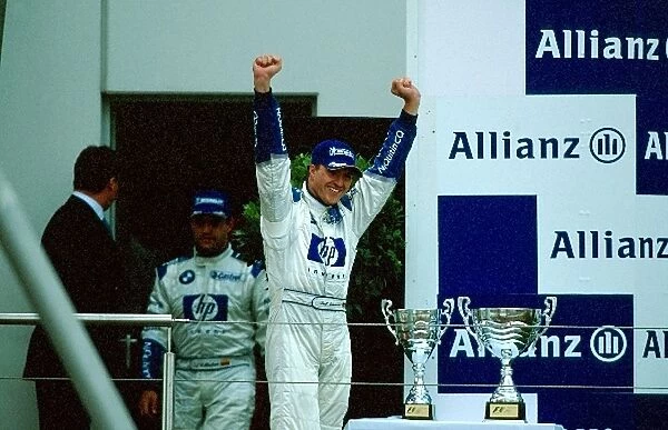 Formula One World Championship: Race winner Ralf Schumacher, BMW Williams, walks onto the podium and acknowledges the crowd