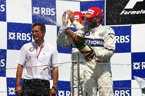 Formula One World Championship: Race winner Robert Kubica BMW Sauber F1 celebrates on the podium with Dr Mario Theissen BMW Sauber F1 Team Principal