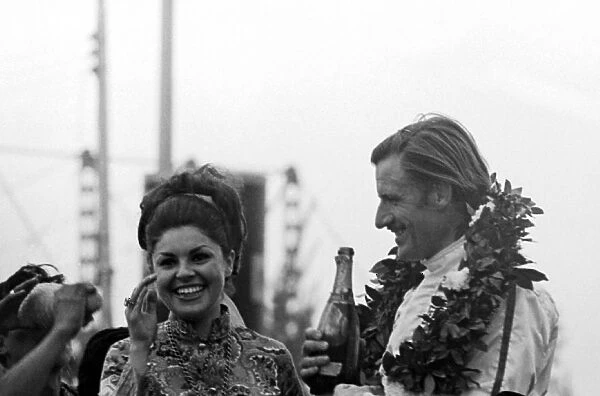 Formula One World Championship: Race winner and World Champion for the second time Graham Hill Lotus enjoys a champagne moment with the girl