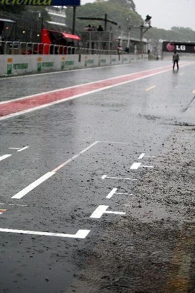 Formula One World Championship: Rain falls in the pits