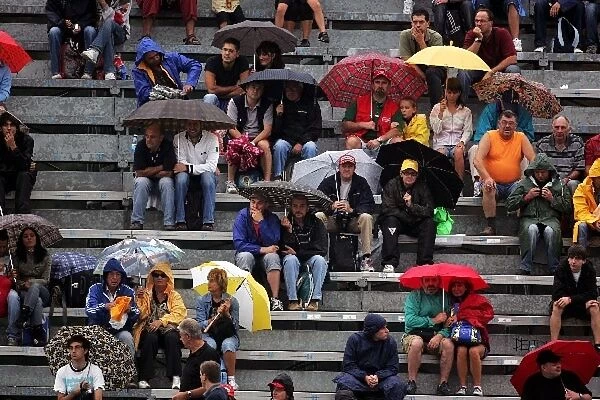 Formula One World Championship: The rain falls down and the umbrellas go up