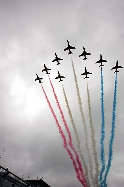 Formula One World Championship: The Red Arrows pass over the grid