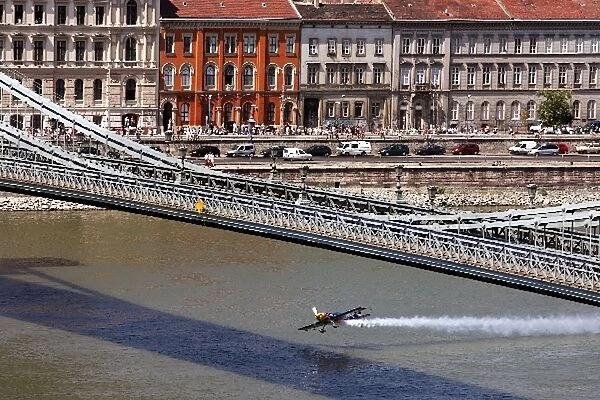 Formula One World Championship: A Red Bull plane flies under a bridge in Budapest