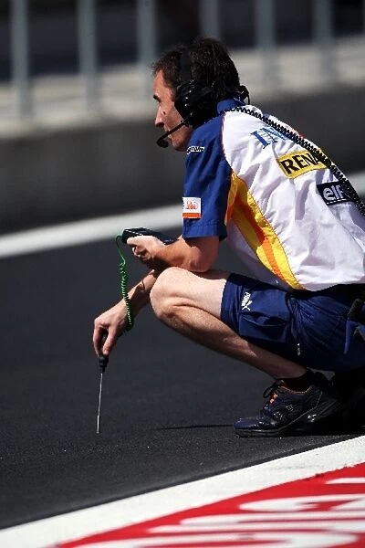 Formula One World Championship: Renault engineer takes a track temperature reading