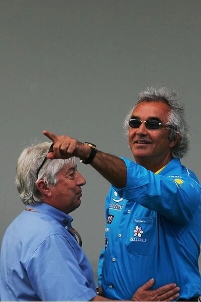 Formula One World Championship: Renault Sporting Director Flavio Briatore, right, celebrates his teams win with Charlie Whiting, FIA
