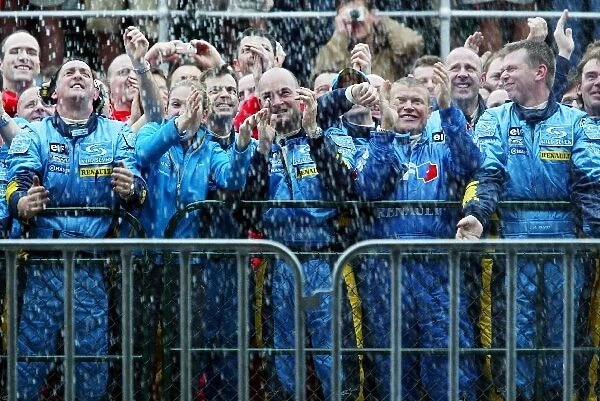 Formula One World Championship: The Renault team are soaked in champagne by third placed Fernando Alonso Renault