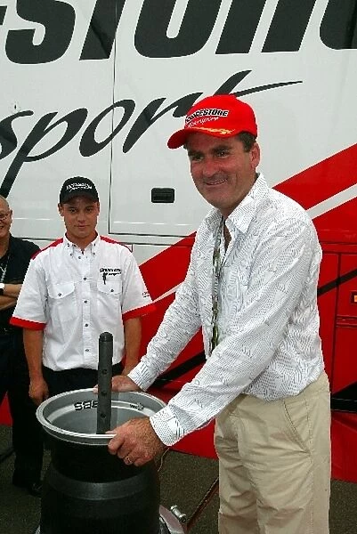 Formula One World Championship: Richard Keys Sky TV Presenter learns how to fit an F1 tyre onto and F1 wheel rim