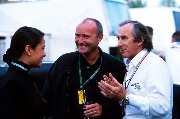 Formula One World Championship: Rock star Phil Collins with Jackie Stewart