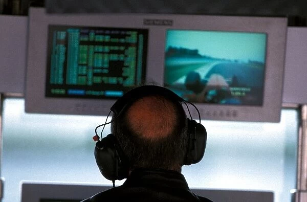 Formula One World Championship: Ron Dennis McLaren Team Owner watches the progress of Michael Schumacher Ferrari on the monitors