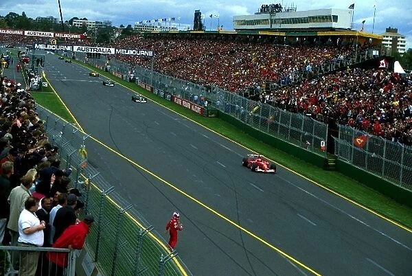 Formula One World Championship: Rubens Barrichello Ferrari watches the field pass behind the safety car whilst running back to the pits