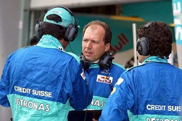 Formula One World Championship: Sauber engineers confer in the pits before the start of the race