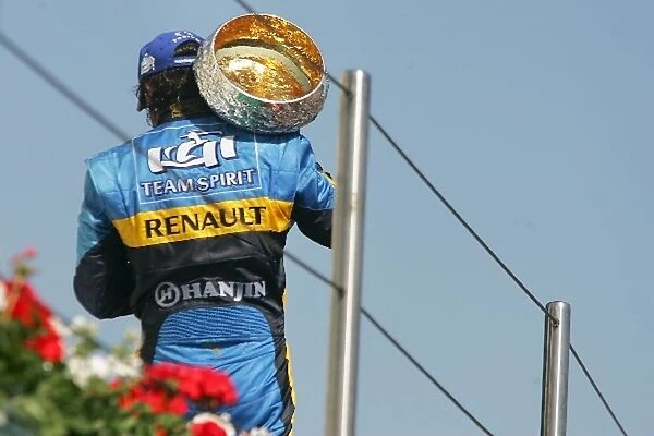 Formula One World Championship: Second place Fernando Alonso Renault on the podium with the trophy