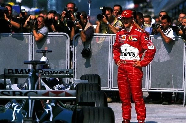 Formula One World Championship: Second place finisher Michael Schumacher, Ferrari, stands in parc ferme
