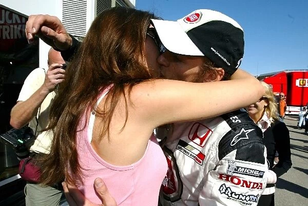 Formula One World Championship: Second placed Jenson Button BAR celebrates with his girlfriend Louise Griffiths