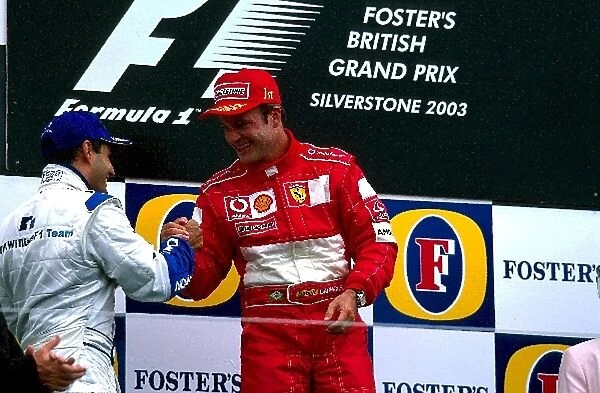 Formula One World Championship: Second placed Juan Pablo Montoya Williams congratulates race winner Rubens Barrichello Ferrari on the podium
