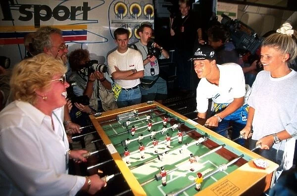 Formula One World Championship: Second placed Michael Schumacher Benetton relaxes playing table football with his parents and his wife Corinna