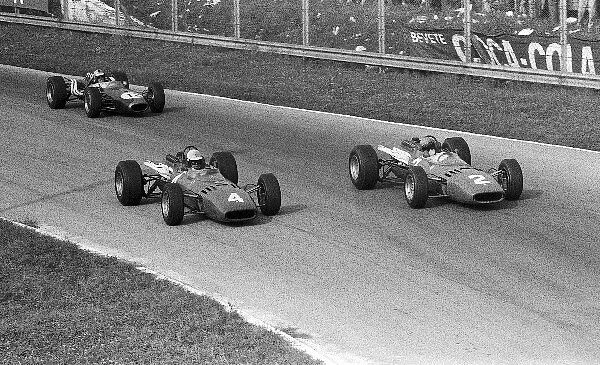 Formula One World Championship: Second placed Mike Parkes Ferrari 312 makes a move on his team mate Lorenzo Bandini who retired on lap 34 with