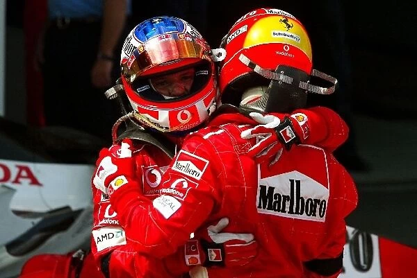 Formula One World Championship: Second placed Rubens Barrichello Ferrari congratulates team mate and race winner Michael Schumacher Ferrari