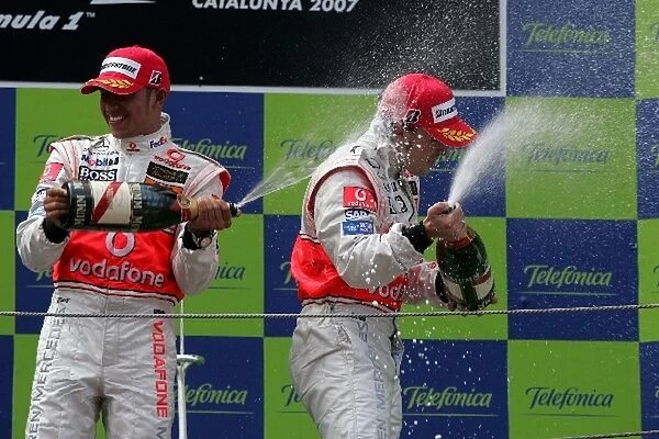 Formula One World Championship: Second plave Lewis Hamilton Mclaren and third place Fernando Alonso McLaren spray the champagne on the podium