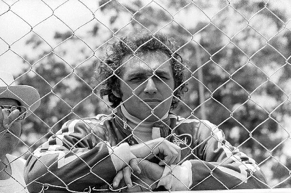 Formula One World Championship: Seventeenth placed Jochen Mass Surtees stands behind a fence
