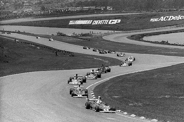 Formula One World Championship: Seventh placed Clay Regazzoni Ferrari 312T, leads at the start of the race from race winner and team mate Niki