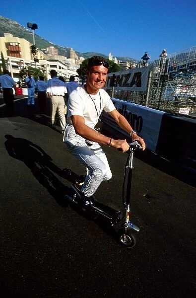 Formula One World Championship: Seventh placed David Coulthard McLaren opts for a small motorised scooter as his preferred mode of transport