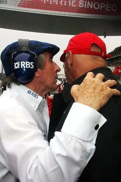 Formula One World Championship: Sir Jackie Stewart with Niki Lauda on the grid