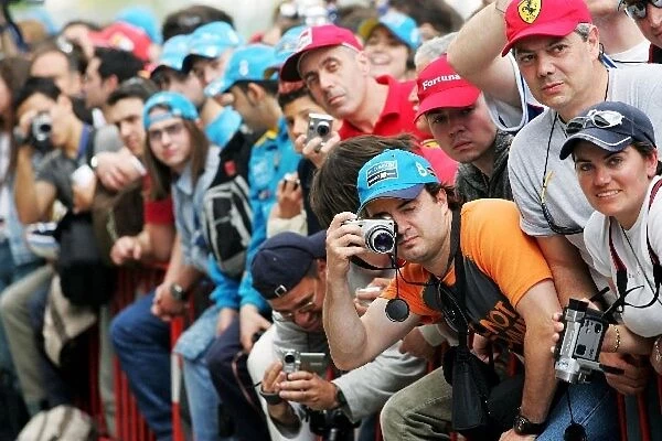 Formula One World Championship: The spectators take advantage of the pit lane being open to photograph their heroes
