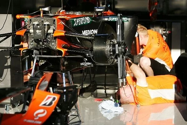 Formula One World Championship: Spyker mechanics work on the cars