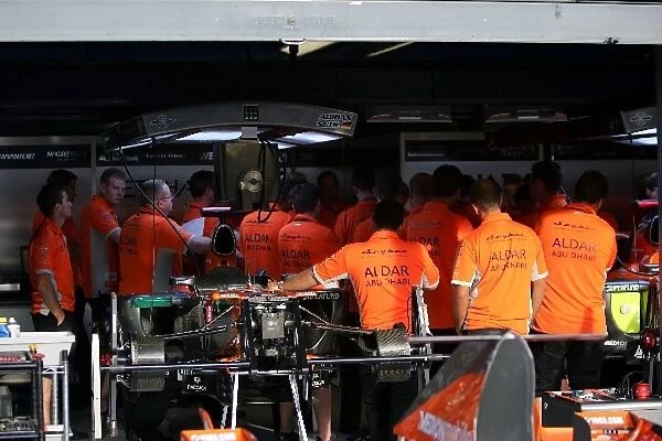 Formula One World Championship: Spyker personnel gather in the garage