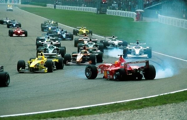 Formula One World Championship: Start accident between Michael Schumacher Ferrari F1 2000 and Giancarlo Fisichella Benetton Playlife B200