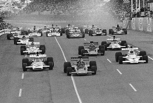 Formula One World Championship: The start with the Lotus of Emerson Fittipaldi getting the jump on the Mclarens of Jody Scheckter left, and Denny Hulme
