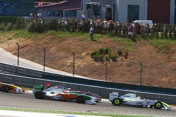 Formula One World Championship: The start of the race including Rubens Barrichello Brawn Grand Prix BGP 001 making a poor getaway