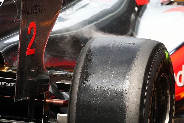 Formula One World Championship: Steaming Bridgestone tyre on the McLaren MP4  /  25 of Lewis Hamilton McLaren
