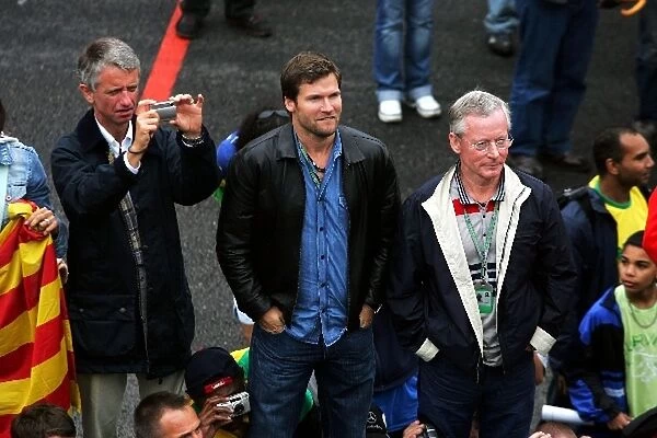 Formula One World Championship: Steve Robertson and Dave Robertson Managers of race winner Kimi Raikkonen watch the podium