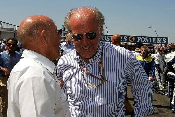 Formula One World Championship: Stirling Moss talks with David Richards on the grid