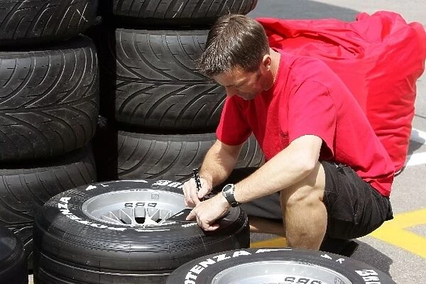 Formula One World Championship: Super Aguri F1Team mechanic works on tyres