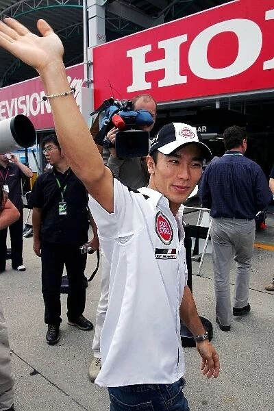 Formula One World Championship: Takuma Sato BAR waves to his fans