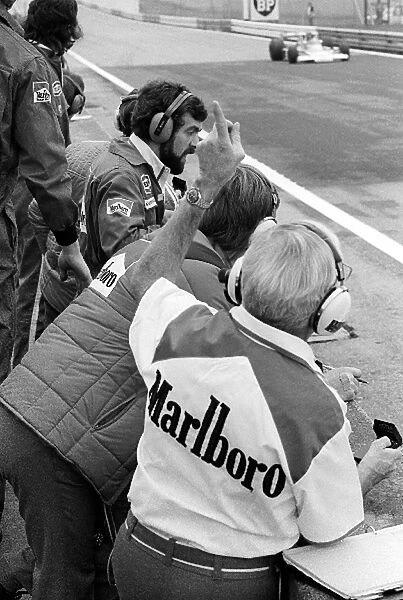 Formula One World Championship: Teddy Mayer McLaren Team Owner gesticulates to fourth placed James Hunt, McLaren M23, from the pit wall