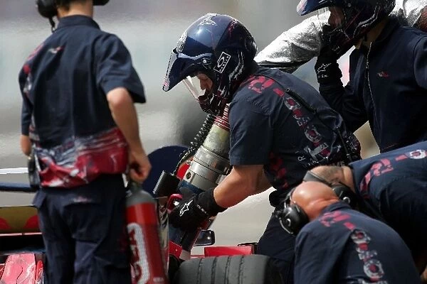 Formula One World Championship: Toro Rosso mechanics practice with the fuel rig
