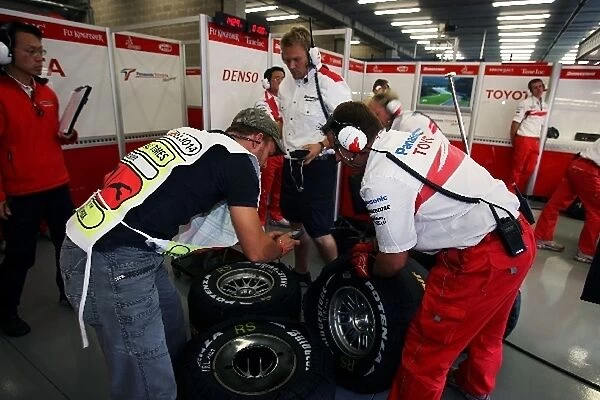 Formula One World Championship: Toyota have their Bridgestone tyres checked by a scruiteneer